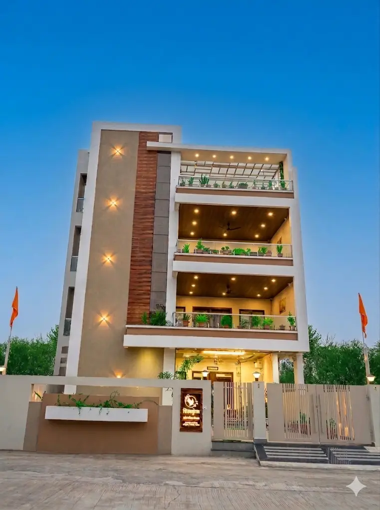 Front of the Shivkunj building at dusk with lit balconies