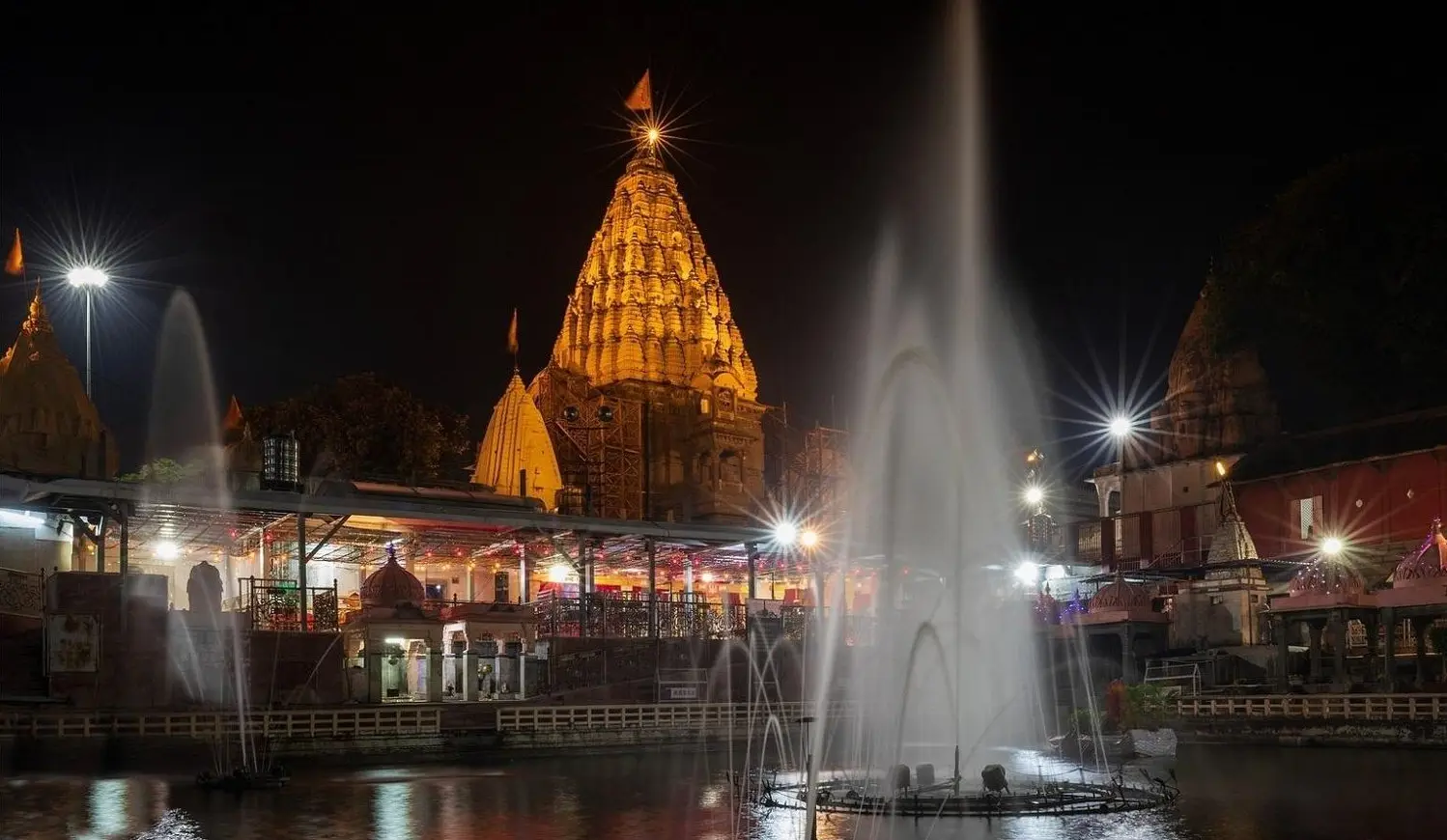 Mahakaleshwar temple lit up at night with fountains in the foreground