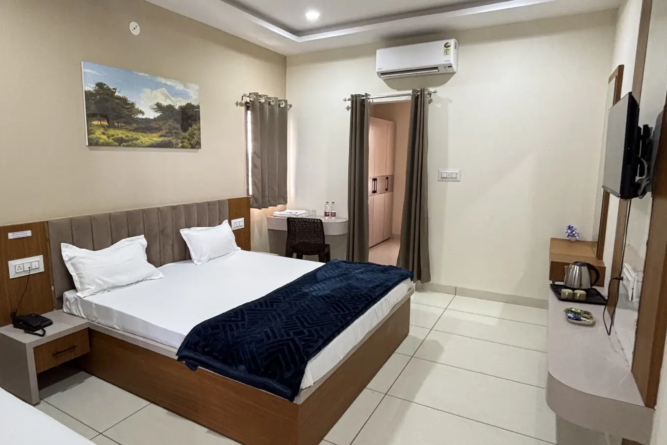 King-size bed with a navy throw and bedside telephone